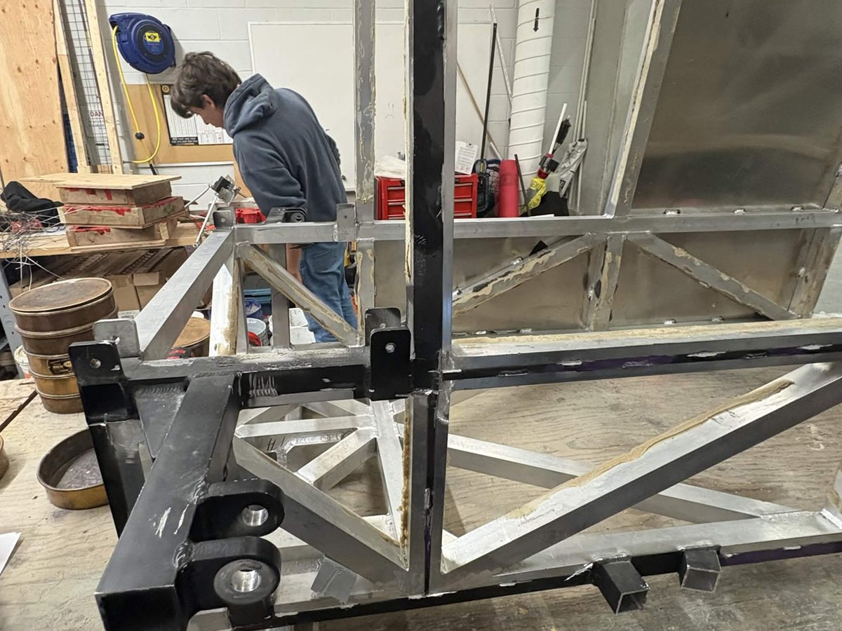 Steel and aluminium toboggan frame on a workbench in the team bay